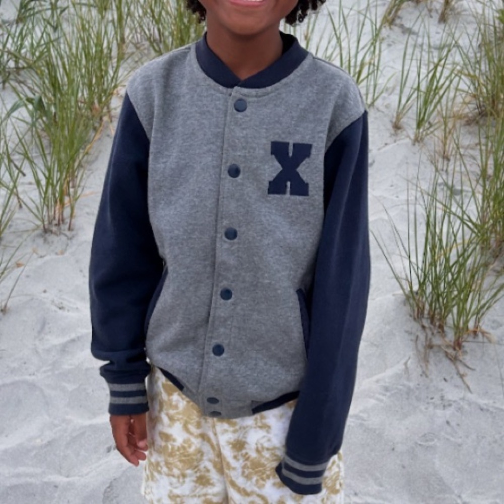 H&M varsity jacket with a large "X" on the chest